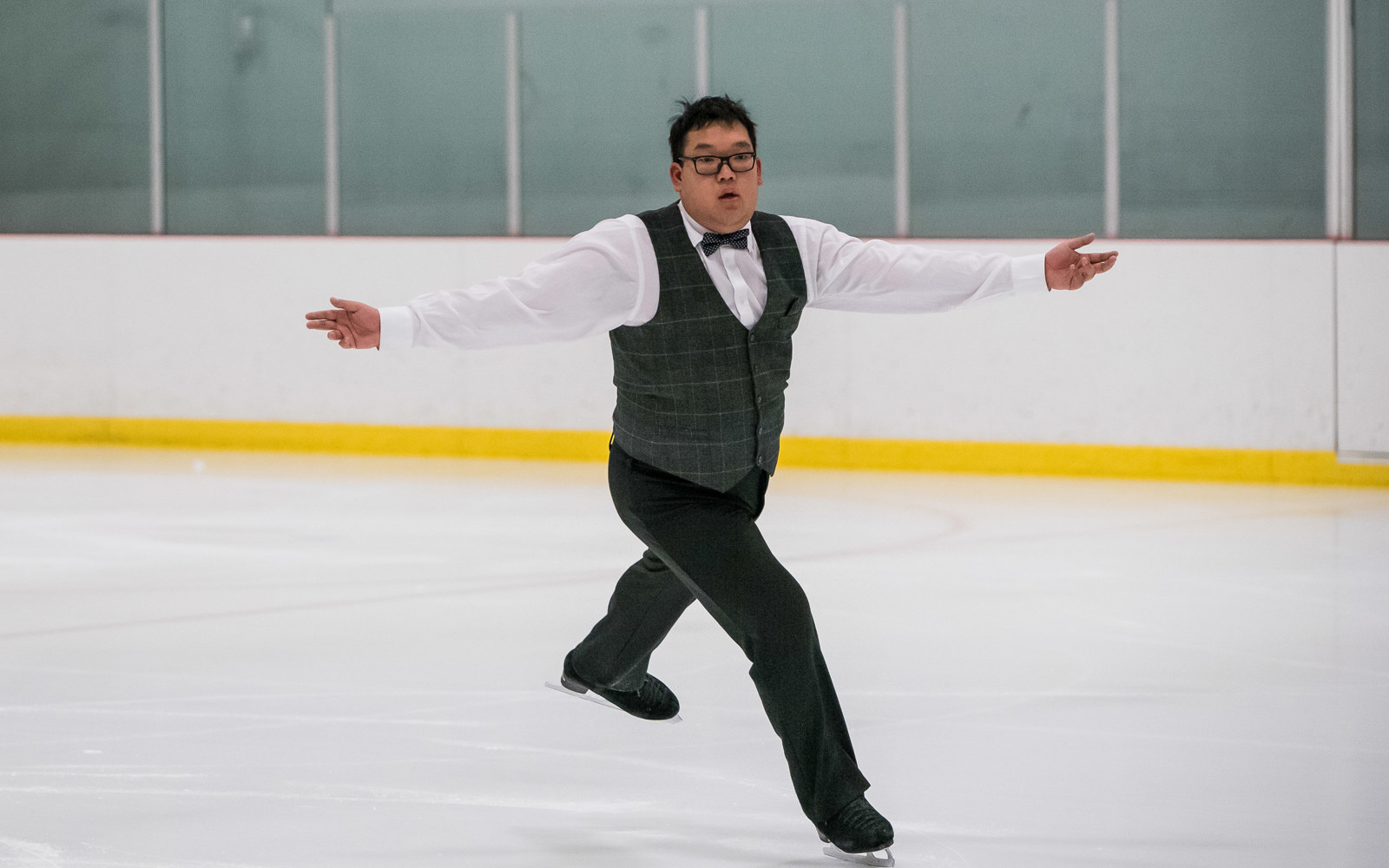 Special Olympics BC - Vancouver figure skating athlete performs with their arms outstretched.