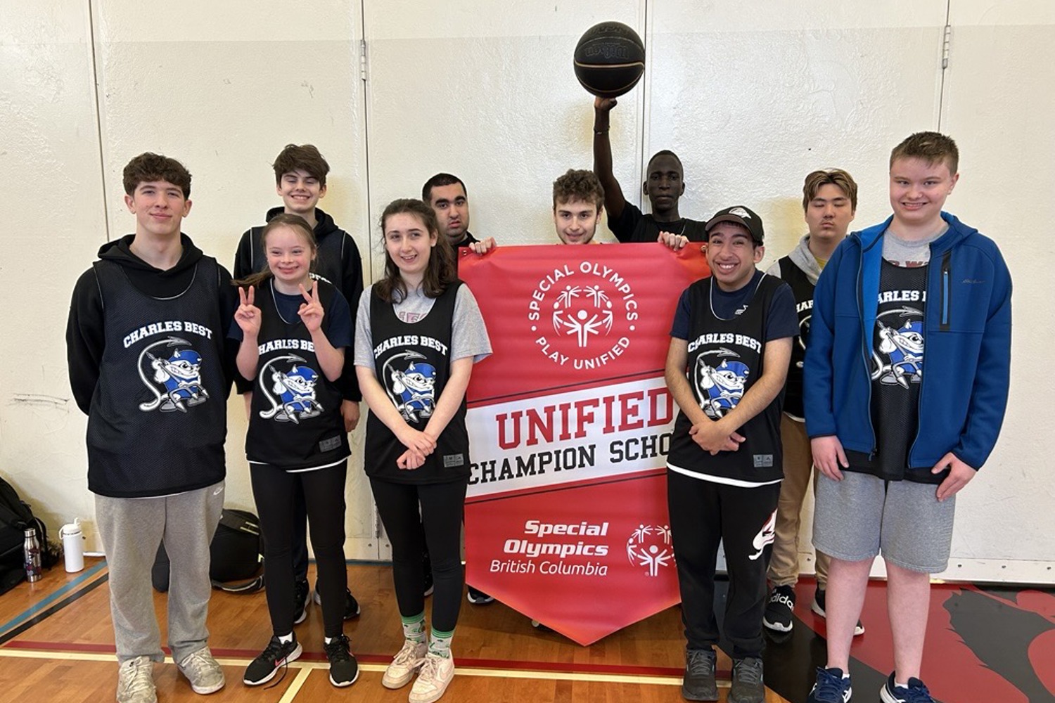Students stand with a Unified Champion School banner.