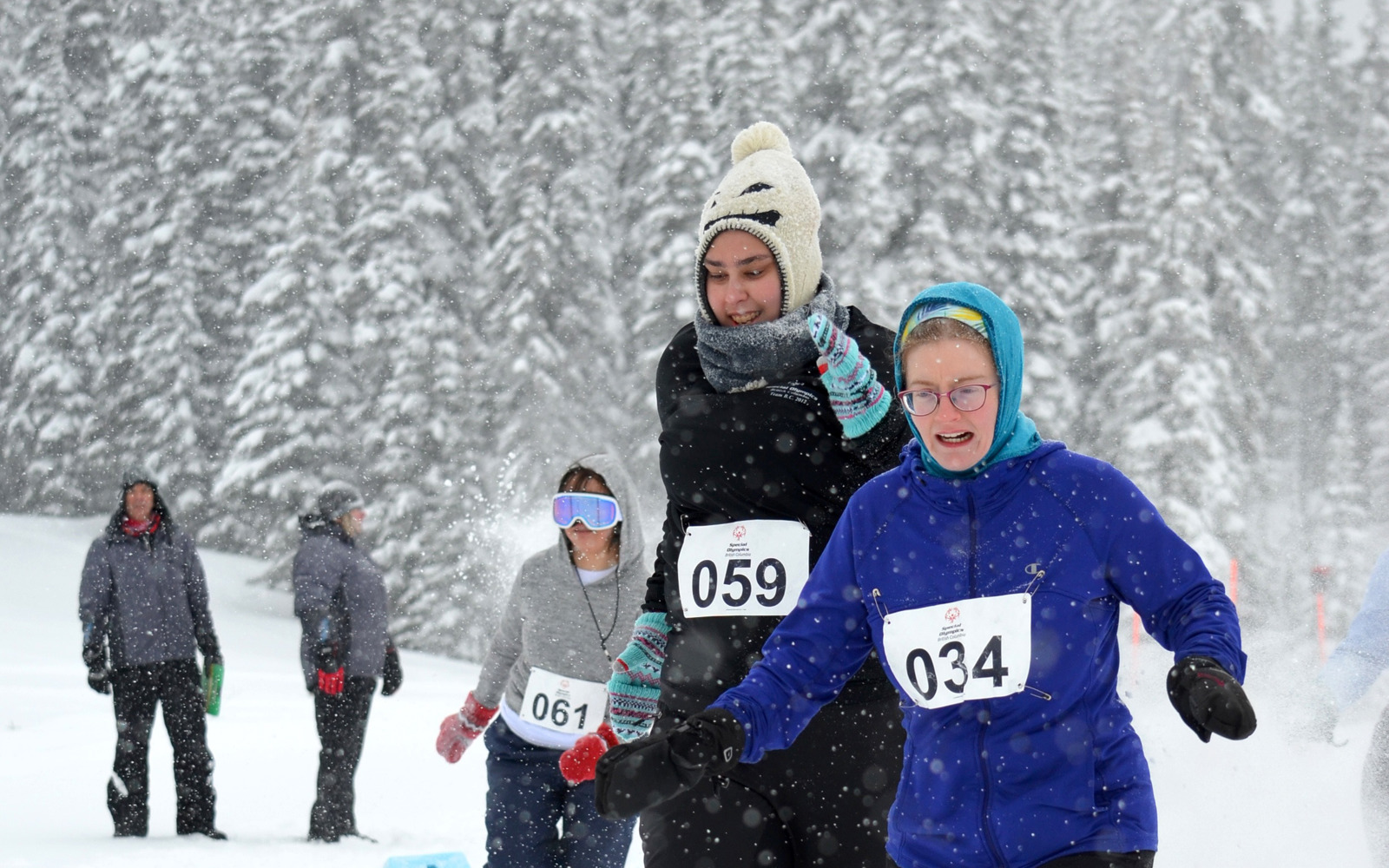 A pair of athletes with intellectual disabilities charge through the snow in their snowshoe race during the 2019 Special Olympics BC Provincial Winter Games.