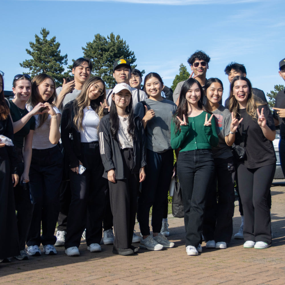A group of volunteers pose together outside the clubhouse.